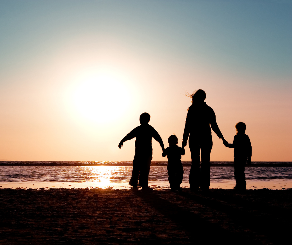 Silhouette of a family against the sun